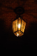 Image showing Ancient lantern on a brick wall