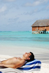 Image showing Young man sunbathing in a Maldivian Island beach