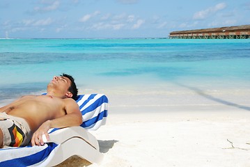 Image showing Young man sunbathing in a Maldivian Island beach