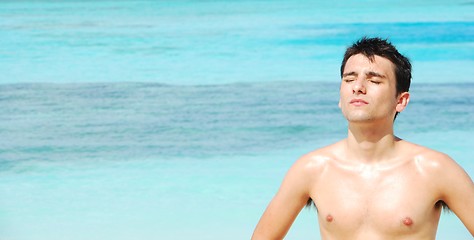 Image showing Man standing up sunbathing in a Maldivian Island