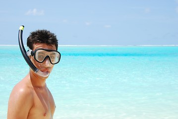 Image showing Young man ready to go snorkeling (blue ocean background)