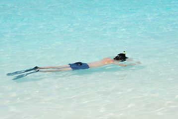 Image showing Young man snorkeling in Maldives (blue ocean water)