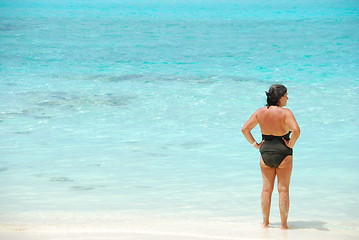 Image showing Senior woman looking at blue vibrant ocean