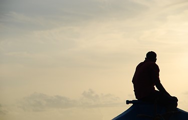 Image showing Silhouette of a fisherman on a typical Dhoni boat (sunset)