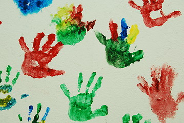 Image showing Wall painted with colorful kids hand prints