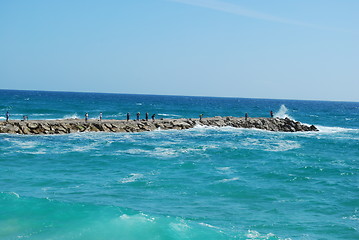 Image showing Rock fishing scene on a wavy ocean