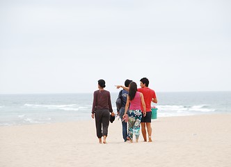 Image showing Beautiful family walking on beach