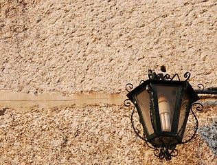 Image showing Old lantern with granite wall background