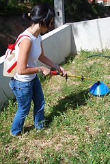 Image showing Young farmer fertilizing the soil