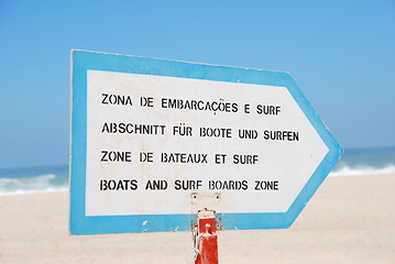 Image showing Boat and Surf sign at the beach