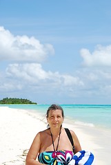 Image showing Beautiful senior woman walking on a tropical beach