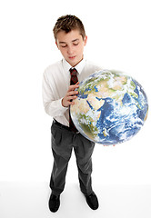 Image showing Boy holding blow up ball of the Earth world