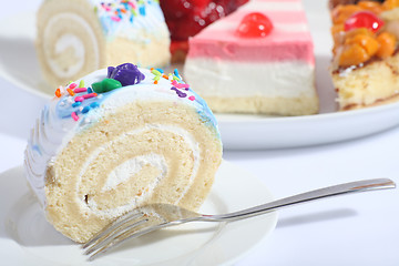 Image showing Sponge roll and plate of cakes