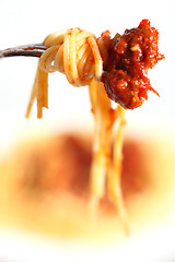 Image showing Spaghetti and a meatball on a fork vertical