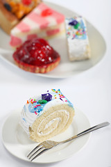 Image showing Sponge roll cake and fork