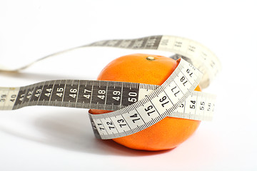 Image showing Metric tape measure and tangerine