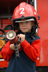 Image showing boy is sitting in a fire truck