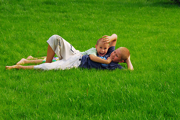 Image showing two boys play on the grass