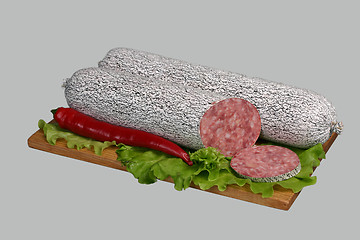 Image showing Salami on wooden board.