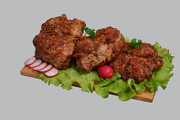 Image showing Smoked chicken kebab on wooden board.