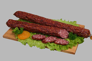 Image showing Smoked sausage on wooden board 2