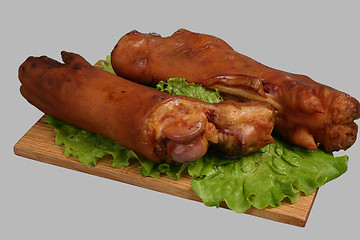 Image showing Smoked trotters on wooden board.