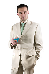 Image showing Businessman celebrating with a glass of drink in a white suit