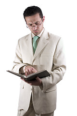 Image showing Businessman with a pair of glassed reading a book