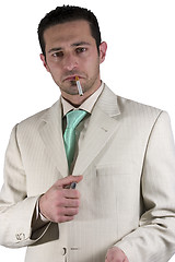 Image showing Businessman lighting up a cigarette