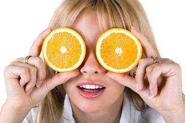 Image showing Portrait of the funny young woman with oranges. Isolated