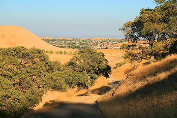 Image showing Windy Road into a City