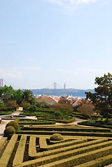 Image showing Enchanted Ajuda garden with April 25th bridge in Lisbon, Portugal