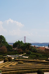 Image showing Enchanted Ajuda garden with April 25th bridge in Lisbon, Portugal