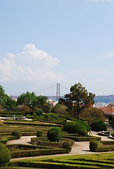 Image showing Enchanted Ajuda garden with April 25th bridge in Lisbon, Portugal