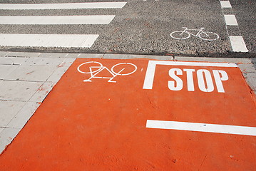 Image showing Orange bicycle lane with a STOP sign