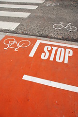 Image showing Orange bicycle lane with a STOP sign