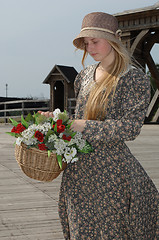 Image showing Girl with basket of flowers