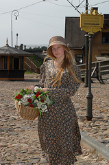 Image showing Girl with basket of flowers