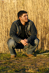 Image showing Young man looking aside with a thoughtful look on his face