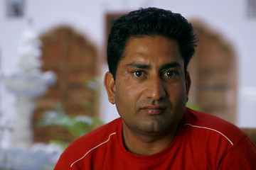 Image showing Handsome but serious Indian man looking straight into the camera