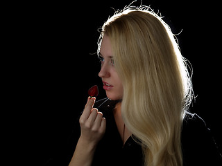 Image showing Girl eating strawberry