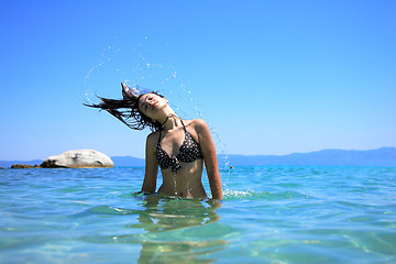 Image showing tanned woman in bikini in the sea