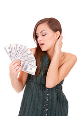 Image showing Attractive woman takes lot of 100 dollar bills