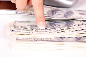 Image showing The businesswoman pointing at money