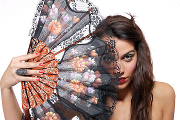 Image showing Spanish  woman behind traditional fan.
