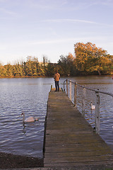 Image showing Man standing on jetty over river