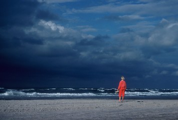 Image showing The girl in red, look out the sea