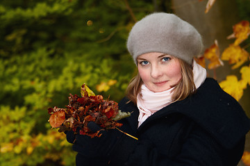 Image showing Autumn - Cute young woman holding leaves