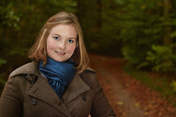 Image showing Freindly young woman standing by a forest path