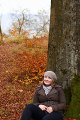 Image showing Fall - Cute young woman looking up at copyspace